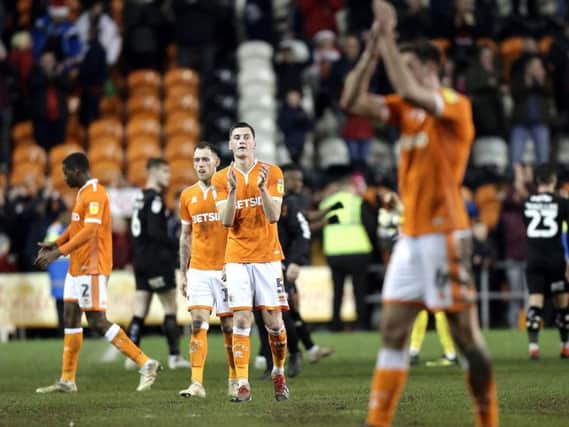 The disappointed Blackpool players applaud the fans at full time