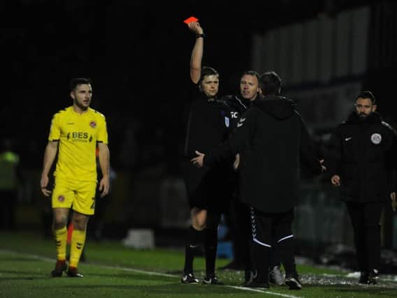 Fleetwood Town boss Joey Barton is shown a red card