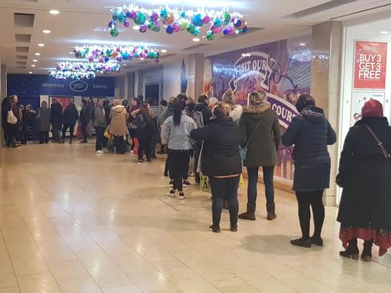 Shoppers wait for Boots to open its Boxing Day sale at Blackpool Houndshill.