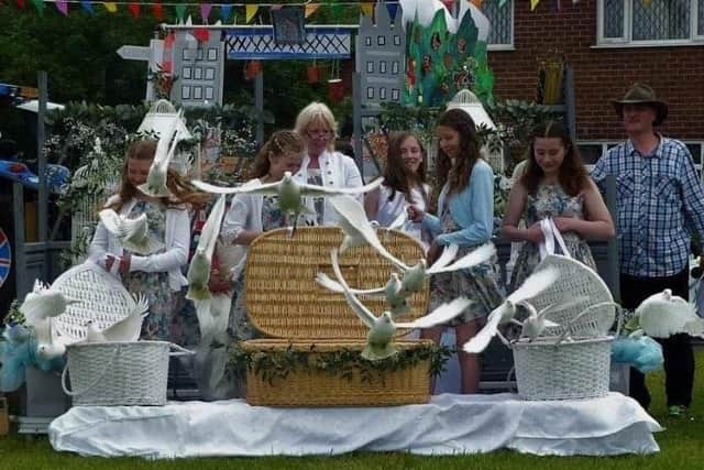 Sue  at a local festival, pictured releasing her doves to mark the centenary of the end of World War One.