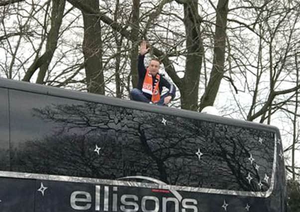 Neil Holden on top of the Arsenal coach on Saturday