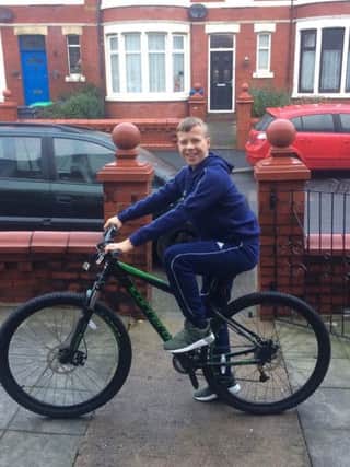 Joshua Walker on the bike that was reported stolen