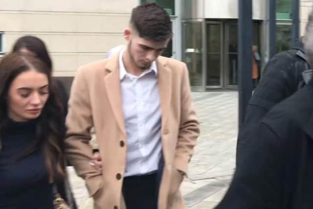 Irish League footballer Jay Donnelly, 23, leaves Belfast Magistrates' Court where he was handed a four-month prison sentence for distributing an indecent image of a child.