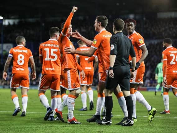 Chris Long celebrates his matchwinner with his new Blackpool teammates
