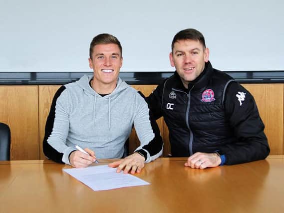Manager Dave Challinor watches Dan Bradley sign for AFC Fylde Picture: AFC FYLDE