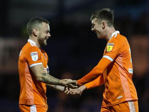 Chris Long celebrates his winning goal at Portsmouth with Blackpool captain Jay Spearing (left)