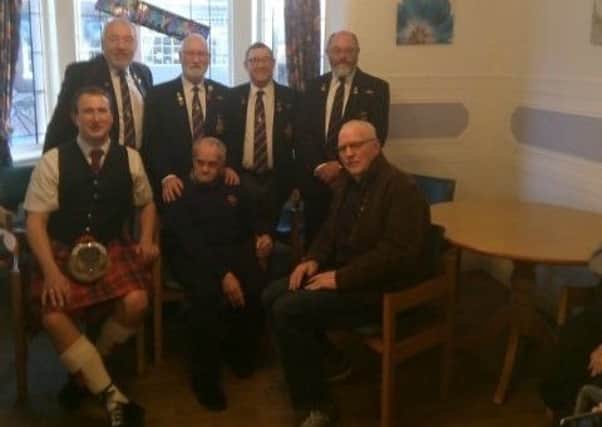 Brian Robinson (pictured sat down in the centre) enjoyed a visit from the Blackpool Submariners Association for his birthday