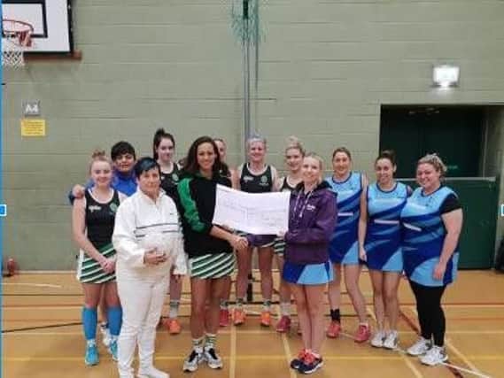 Irene Rawcliffe, chair of Fylde Netball League, and Terri Williams, tournament secretary, present cheques to Claire Upton, Stroke Support Co-ordinator at Stroke Association,and Sarah Green, North West Regional fundraiser for Parkinsons UK.