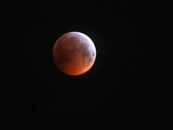 A super blood wolf moon in the sky during a lunar eclipse.