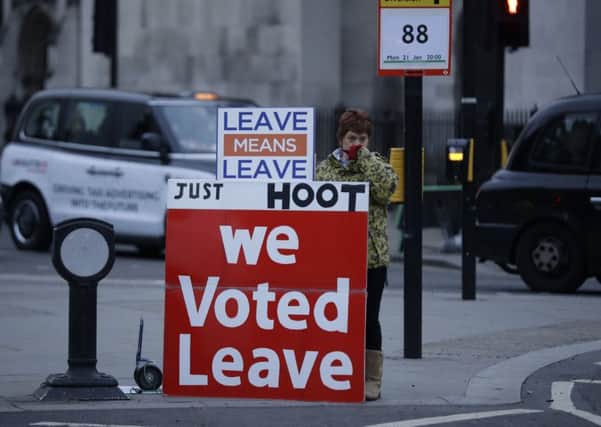 A pro-Brexit leave the European Union supporter demonstrates with placards outside the Houses of Parliament in London.