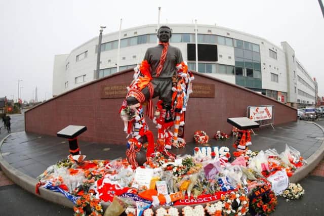 Flags are draped around Jimmy Armfield's statue