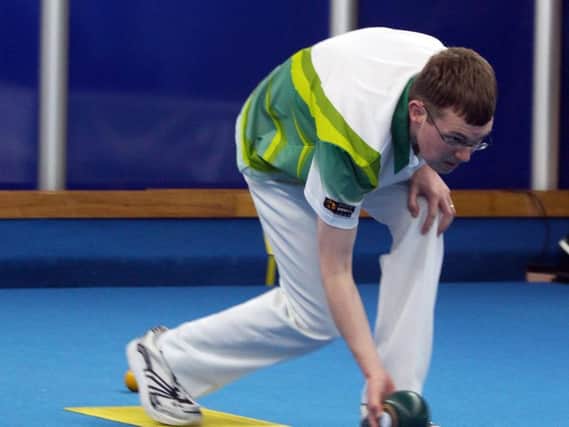 Mark Dawes' bid to defend his world indoor bowling titles has ended in Norfolk