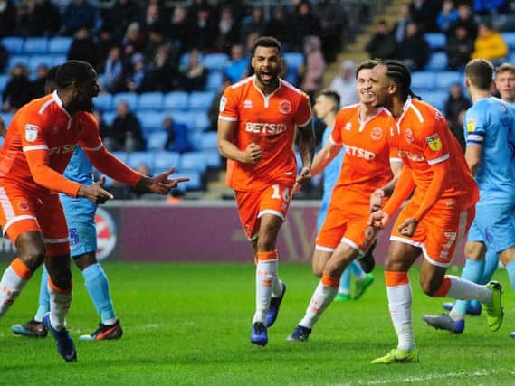 Nathan Delfouneso celebrates giving Blackpool the lead against his former club