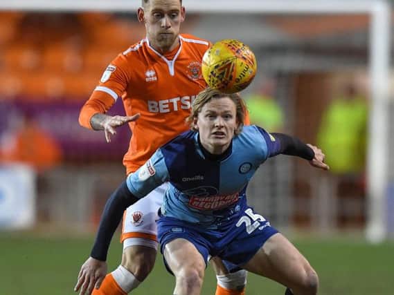 Blackpool goal hero Harry Pritchard challenges Wycombe's Alex Samuel