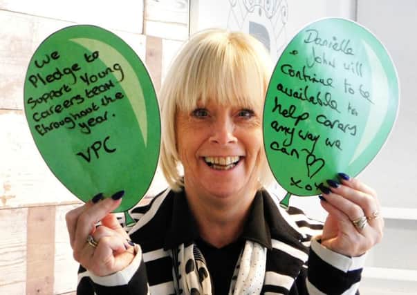 Blackpool Carers Centre head of fundraising Terry Hodkinson with two balloon pledges on Young Carers Awareness Day