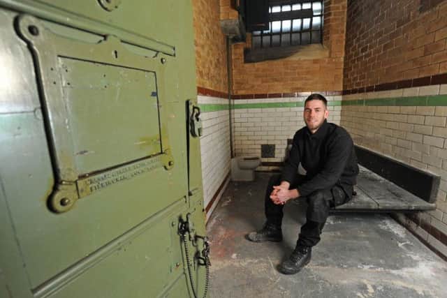 Maintenance technician at Blackpool's Divisional HQ Caleb Bohen inside the old cell.