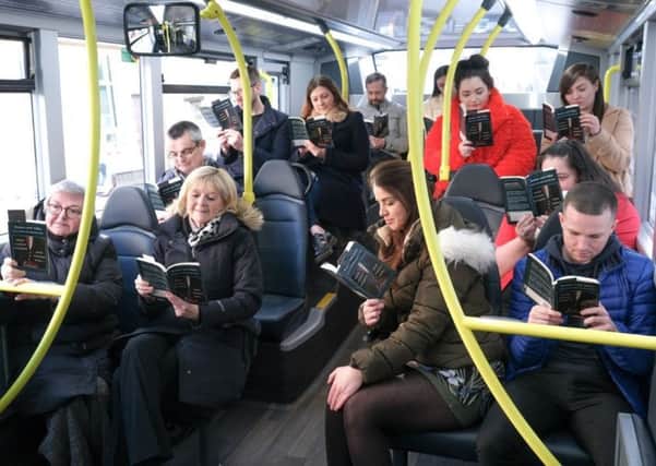 People reading Romeo and Juliet on the bus. Picture provided by the Grand Theatre