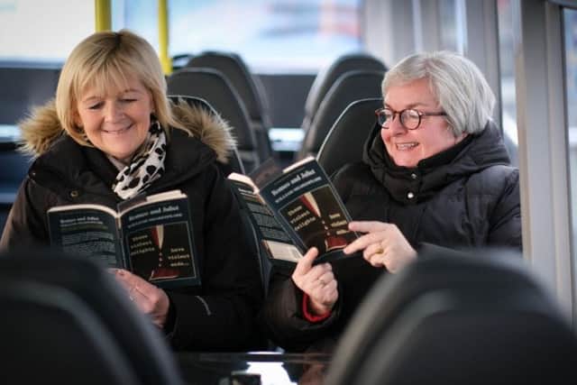 Blackpool Transport managing director Jane Cole and Grand Theatre chief executive Ruth Eastwood reading Romeo and Juliet on the bus. Picture provided by the Grand Theatre