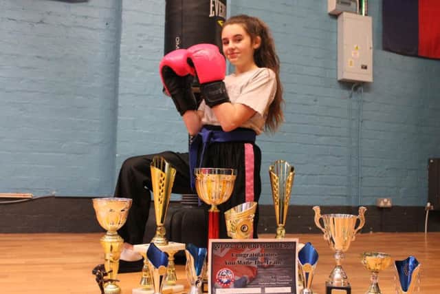 Triniti Lyttle with her martial arts trophies
