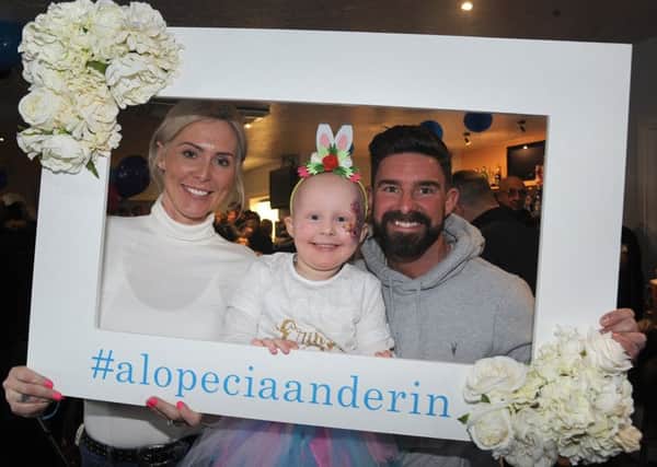 Tom and Jamie Didlock organised a family fun day at Thornton Cleveleys Football Club to raise funds for Alopecia Awareness, a condition their daughter Erin (4) has.
Erin with her parents.  PIC BY ROB LOCK
3-2-2019