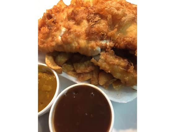 Fish, chips, gravy and curry sauce