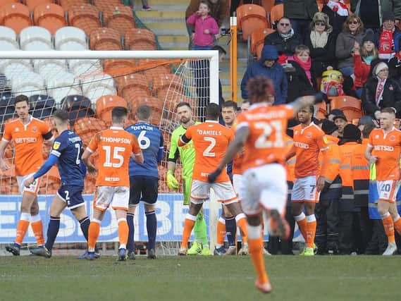 Mark Howard is swarmed by his Blackpool teammates after saving Matt Jarvis' penalty