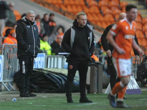 Walsall manager Dean Keates watches on from the sidelines with Terry McPhillips in the background
