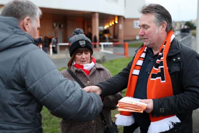 Tim Fielding, right, handing out leaflets as part of the ongoing Oyston Out fans campaign