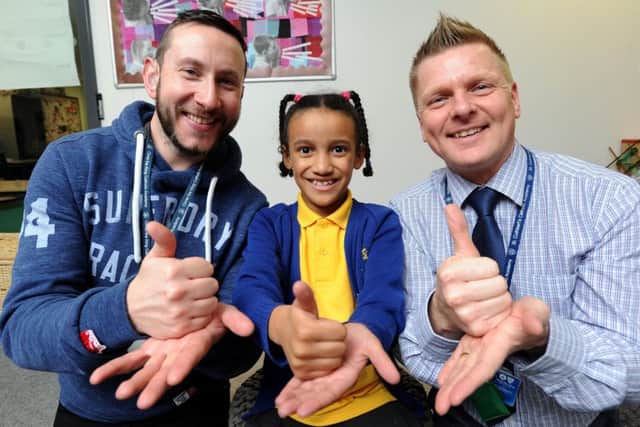 Pupils at Christ The King have been learning to sign and sing a song to support Deaf Awareness and Deaf Children in Education.  Pictured L-R are communications support worker Martyn Kenyon, 7-year-old pupil Eniola Arisekola-Ojo and assistant headteacher and SENCO Daniel Flannigan-Salmon.