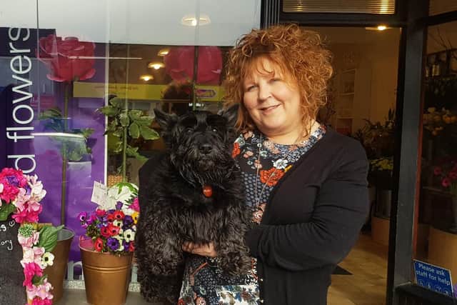 Jenny Greenwood, who runs Flowers Galore, with Jock the Scottish Terrier.