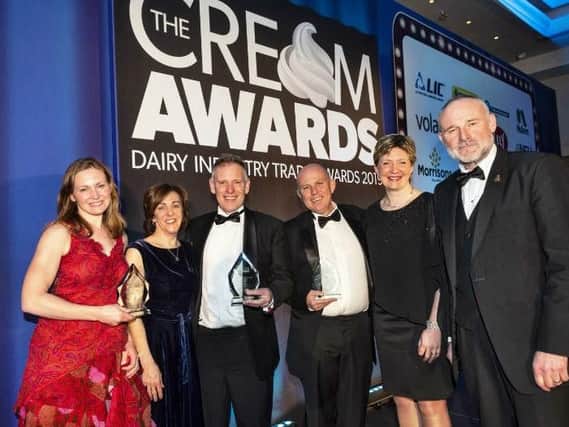 Karen and John Bradley, second and third left, receiving their Cream Award for Derby Hill Dairy's chocolate milk