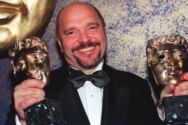 Anthony Minghella, director of The English Patient, with his awards for Best Film and  Best Screenplay (Adapted) at the Royal Albert Hall, in London, at the 1997 BAFTA award ceremony.