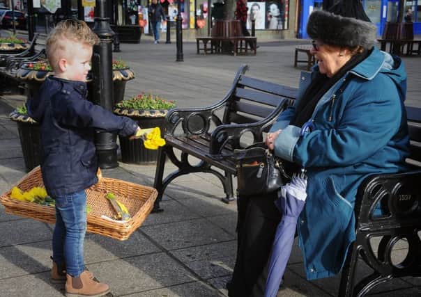 4 year-old Louie Ratcliffe joined his mum Rachael Irvine in handing out free daffodils to locals to mark Valentine's Day.
Louie hands out flowers.  PIC BY ROB LOCK
14-2-2019