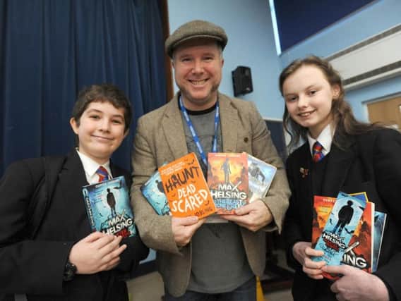 Author and illustrator Curtis Jobling pays a visit to pupils at Cardinal Allen and Baines.  He is pictured with Cardinal Allen pupils Kaid Dervishaj and Jennifer Beaumont.