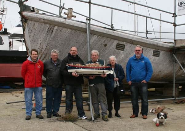 Members of the Ann Letitia Russell Rescue Group alongside the Ann Letitia Russell with a model of the Ann Letitia Russell