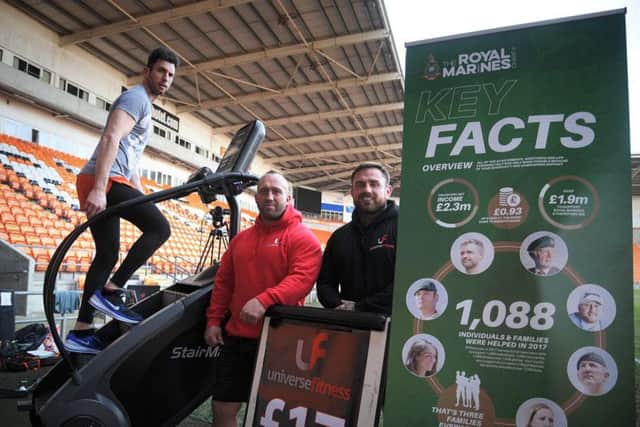 Matthew Disney taking on his challenge at Bloomfield Road in memory of Darren Daz Smith, as  Carl Etherington and Joseph Nicholson of Universe Gym who are supporting him watch on