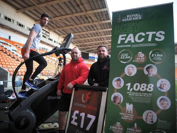 Matthew Disney taking on his challenge at Bloomfield Road in memory of Darren Daz Smith, as  Carl Etherington and Joseph Nicholson of Universe Gym who are supporting him watch on