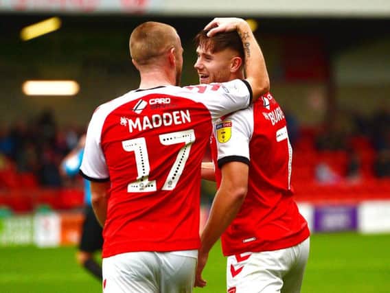 Paddy Madden and Wes Burns embrace after another Fleetwood Town goal