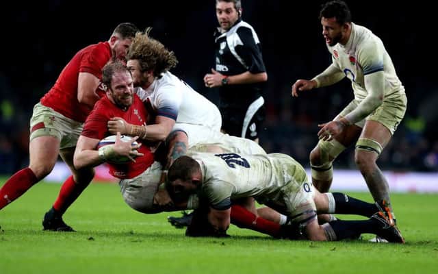 Wales' Alun Wyn Jones (second left) is tackled during the NatWest 6 Nations match at Twickenham Stadium, London. PRESS ASSOCIATION Photo. Picture date: Saturday February 10, 2018. See PA story RUGBYU England. Photo credit should read: Gareth Fuller/PA Wire. RESTRICTIONS: Editorial use only, No commercial use without prior permission.