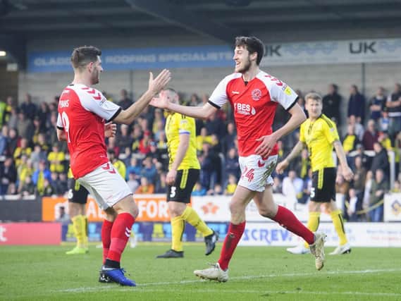 Ashley Nadesan celebrates Fleetwood's winner at Burton with Ched Evans