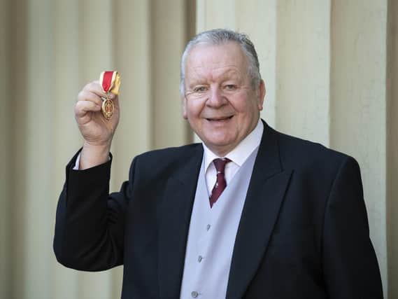 Bill Beaumont receiving his knighthood at Buckingham Palace