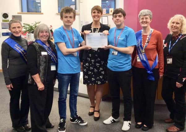 Blackpool Sixth Form College pupils with the principal Jill Gray and club members receiving a Toilet Twinning plaque in December 2018