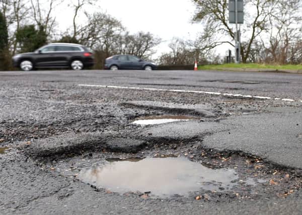 A file image, dated April 4, 2018, of a pothole in a road