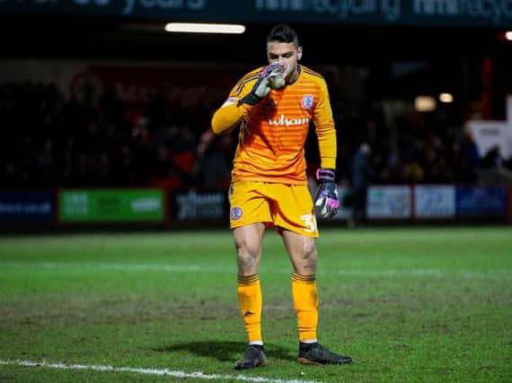 Accrington keeper Dimitar Evtimov jokingly pretends to drink from the cup prior to his sending off