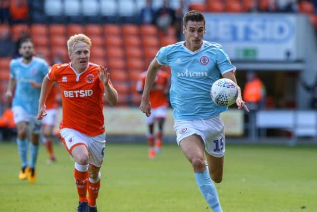 Blackpool's Mark Cullen vies for possession with Accrington Stanley's Ross Sykes