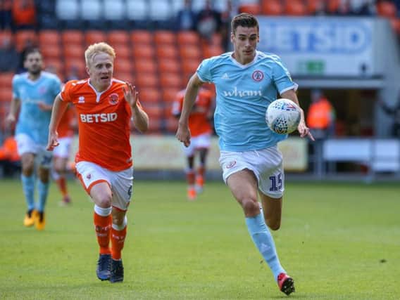 Blackpool's Mark Cullen vies for possession with Accrington Stanley's Ross Sykes