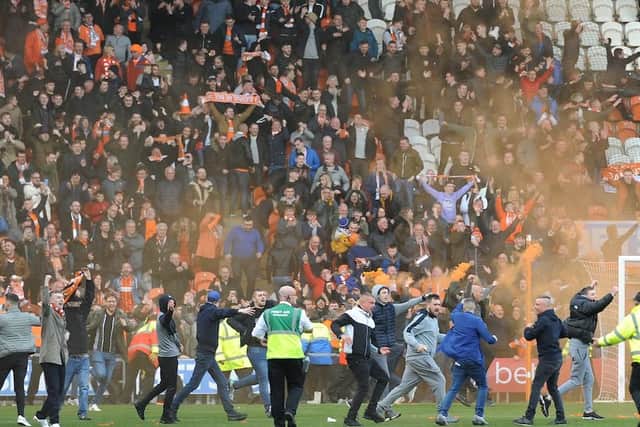 Fans invade the pitch to celebrate Blackpool's 96th-minute equaliser
