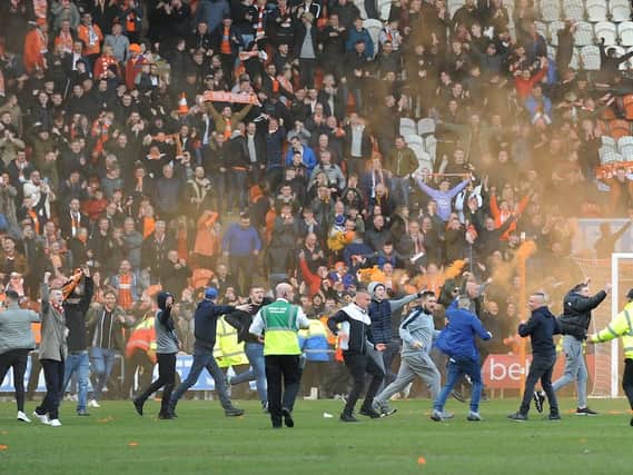 Fans invade the pitch to celebrate Blackpool's 96th-minute equaliser
