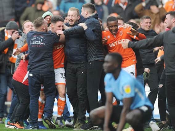 Blackpool's players are mobbed after their 96th-minute equaliser