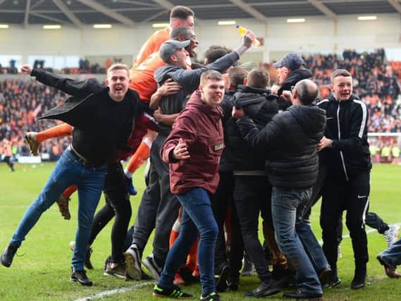 Supporters mobbed the Blackpool players after their stoppage time equaliser